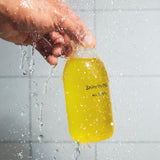 Shinrin-Yoku All Over Oil Bottle in a bathroom setting with splashes of water.