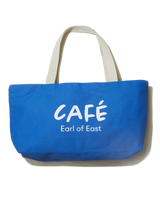 A blue cotton canvas market bag with cream handles and the text 'CAFÉ Earl of East' printed on the side.