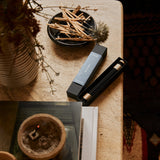 Japanese incense sticks displayed in a serene home environment with natural elements