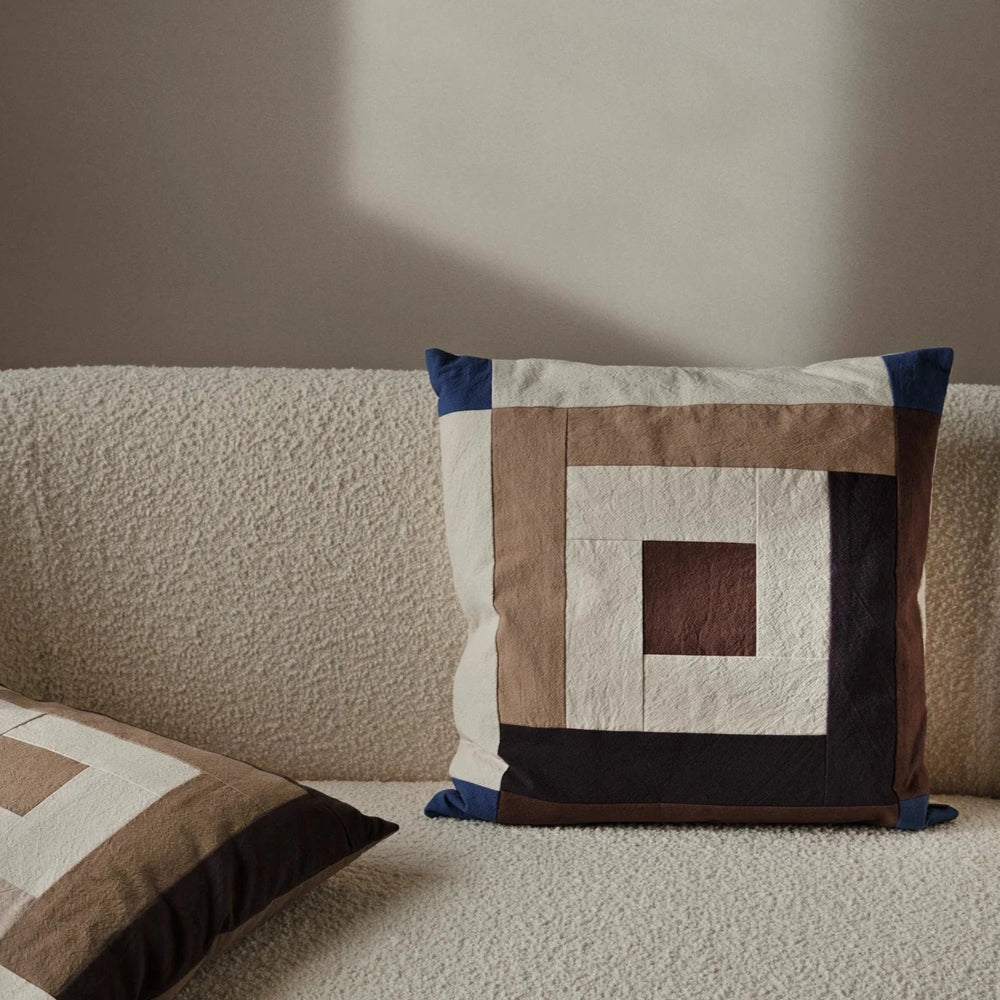 Border Patchwork Cushion, Brown & Blue by ferm LIVING, on a cream sofa