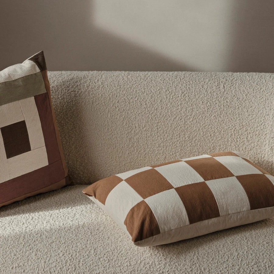 Fold Patchwork Cushion, Sugar Kelp by ferm LIVING, on a cream sofa