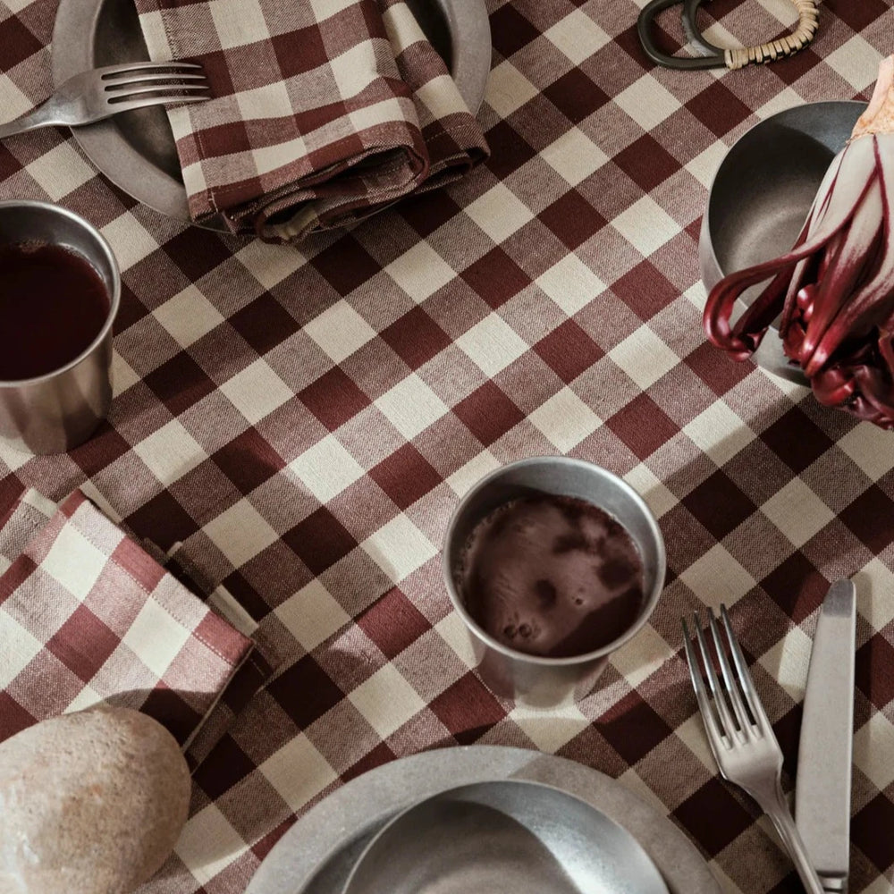 Tumbled Cup, Stainless Steel by ferm LIVING, on a red gingham tablecloth