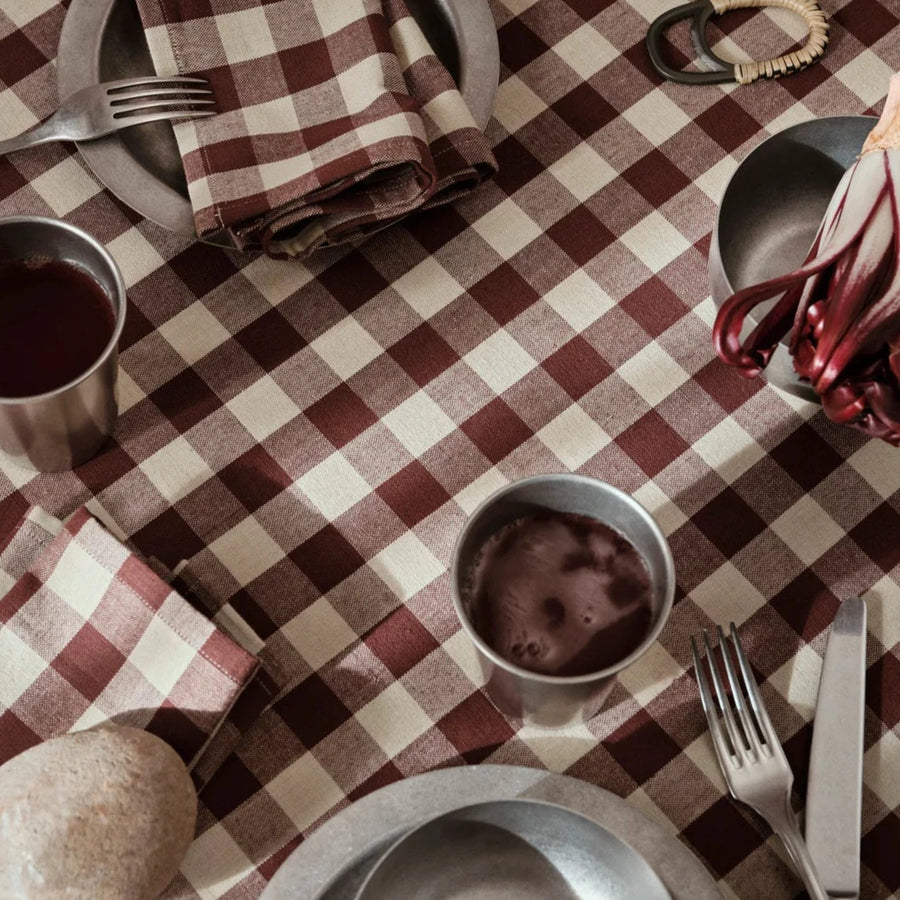 Tumbled Plate, Stainless Steel by ferm LIVING, on a red gingham tablecloth