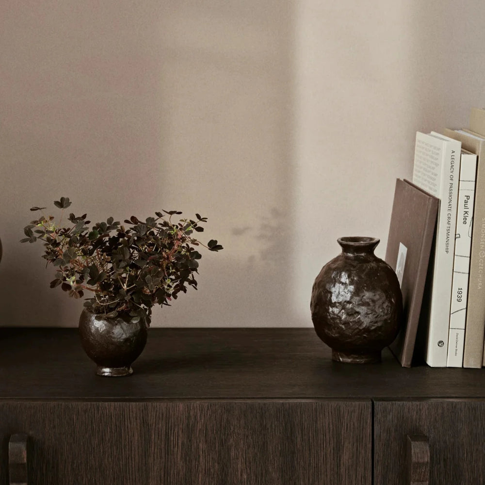Doro Vase, Medium, Coffee by ferm LIVING, on a dark sideboard