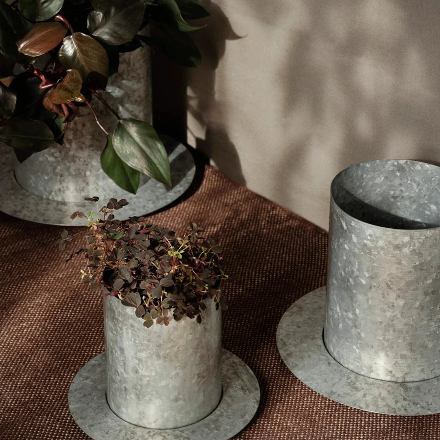 Auran Pot, Galvanized, Medium by ferm LIVING, on a wooden table with ceramics