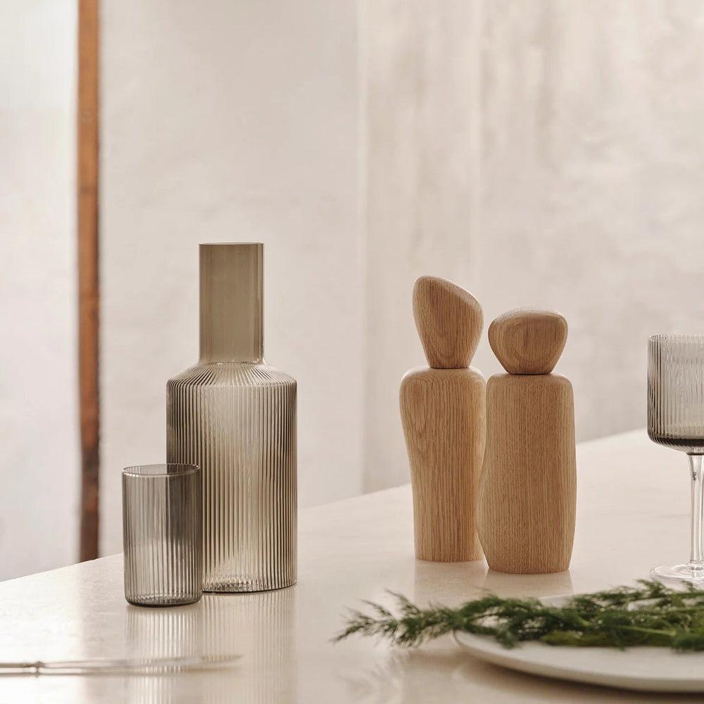 Wooden Pebble Grinder for Salt & Pepper, Light Wood by ferm LIVING, on a kitchen counter with other grinders