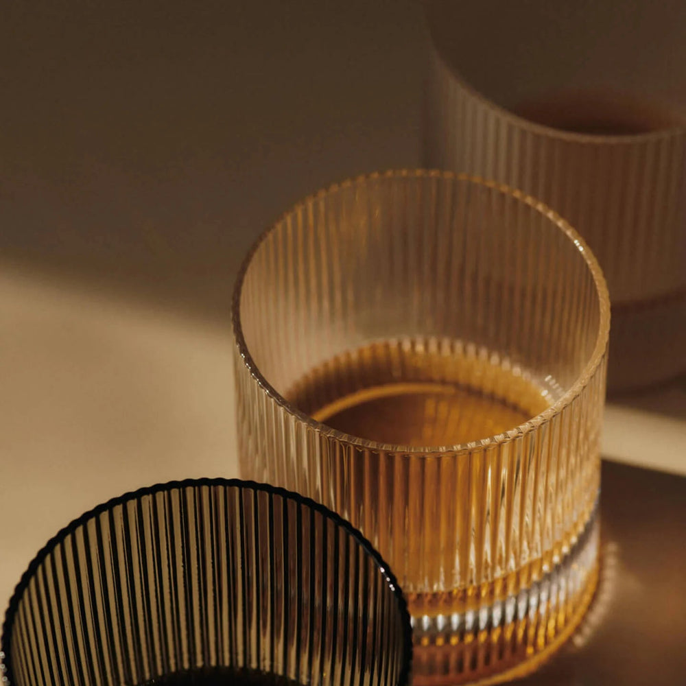 Ripple Tumbler Glasses, Set of 2 by ferm LIVING, holding whisky in warm light