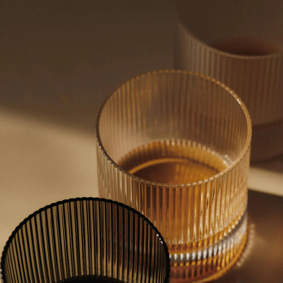 Ripple Tumbler Glasses, Set of 2 by ferm LIVING, holding whisky in warm light