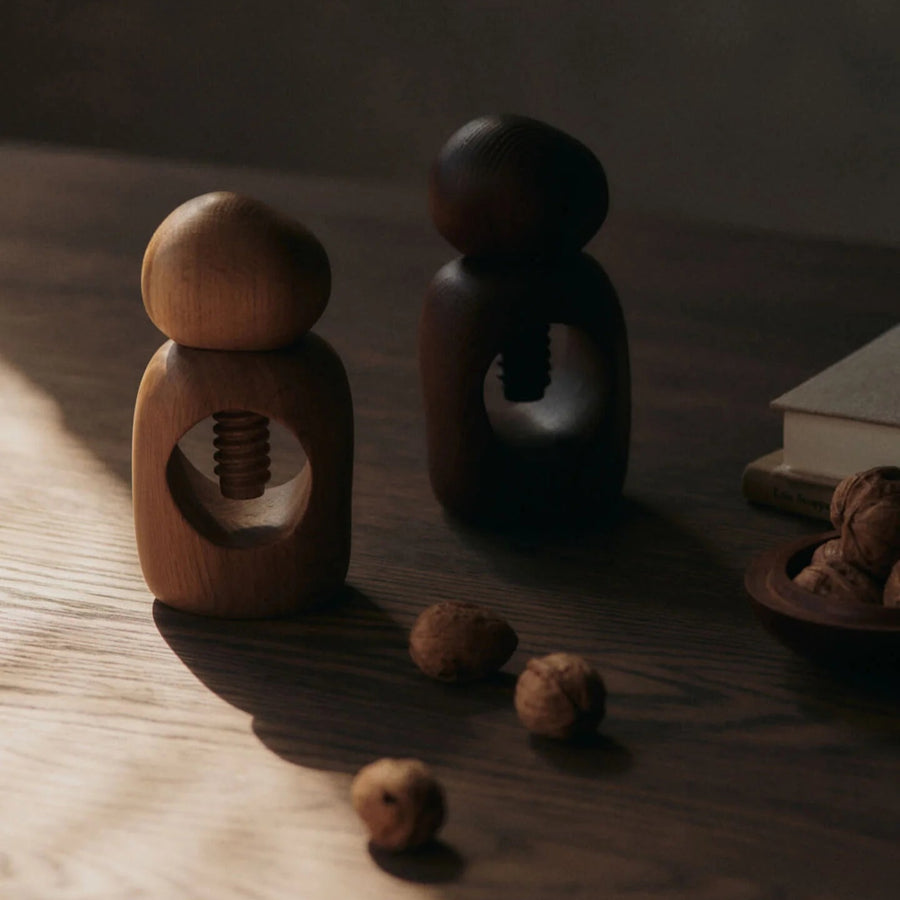 Cairn Nut Cracker, Oak by ferm LIVING, on a dark table