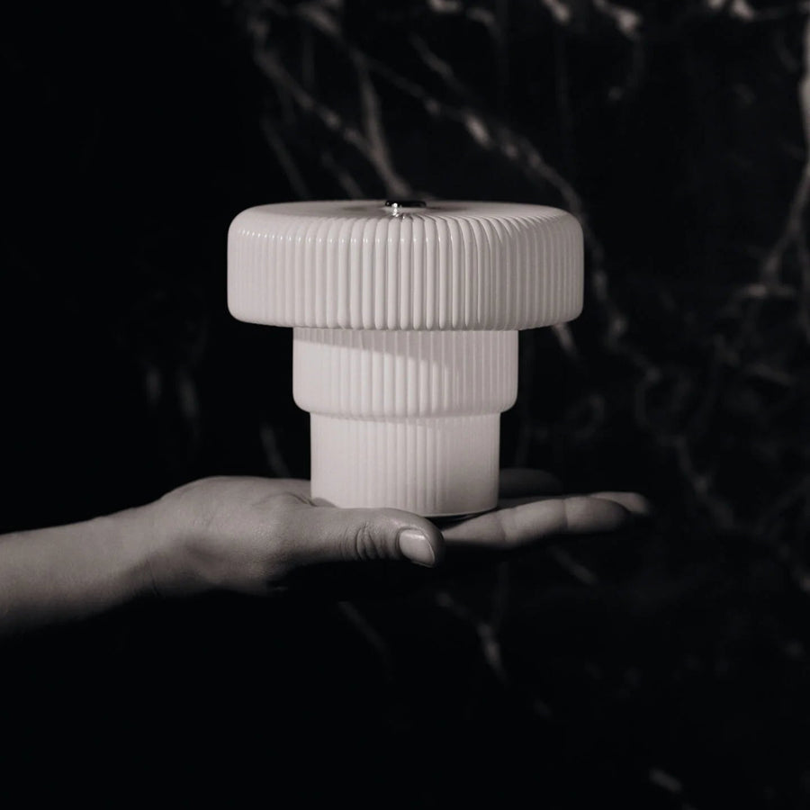 Ripple Portable Lamp, Small, White by ferm LIVING, held in hand