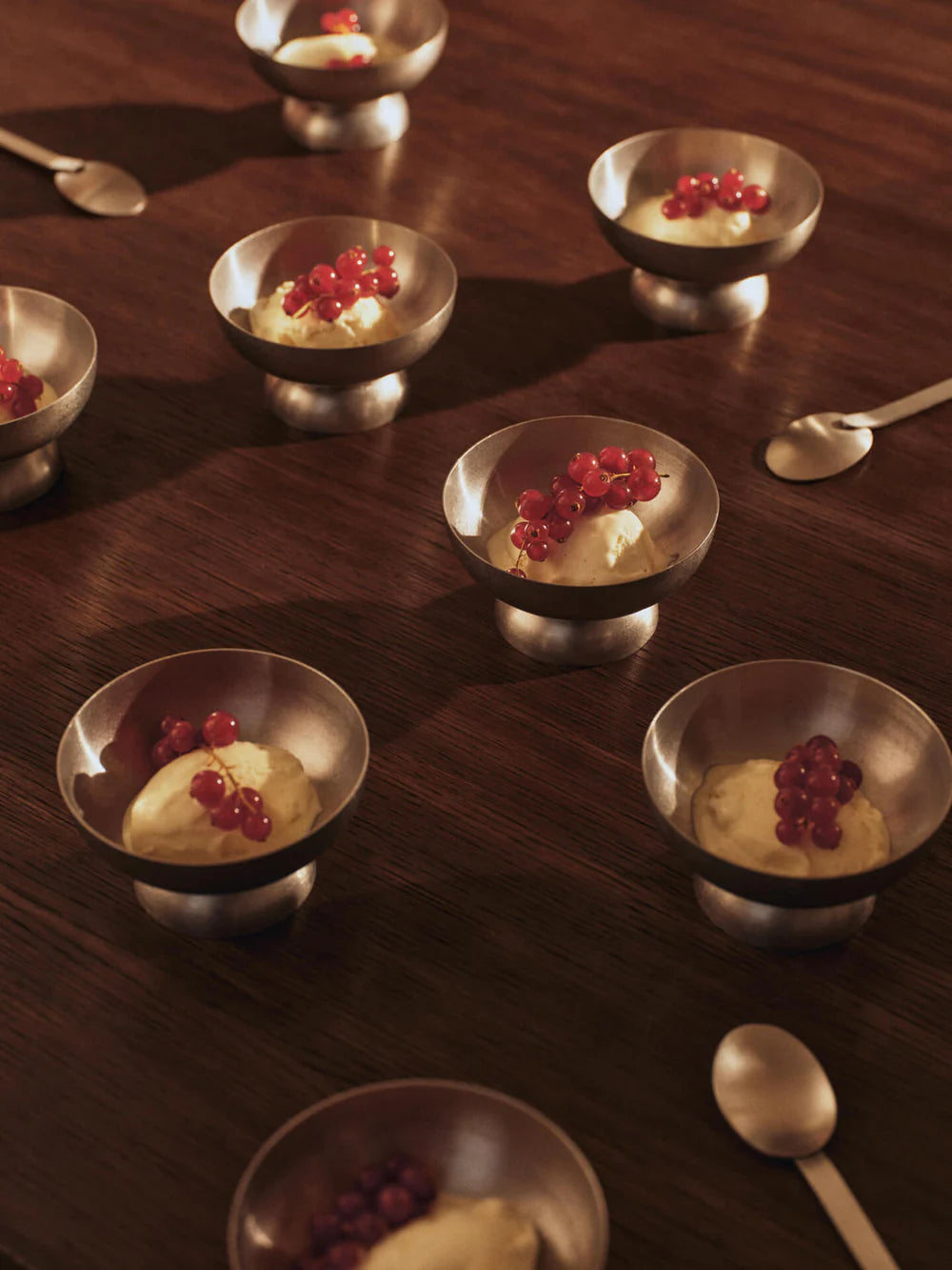 Tumbled Ice Cream Bowl, Tumbled Steel by ferm LIVING, holding desserts on a dark table