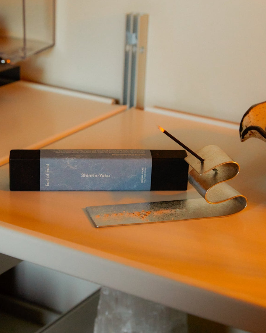 Tin Incense Holder, Silver by Japacolle, holding incense on an orange surface