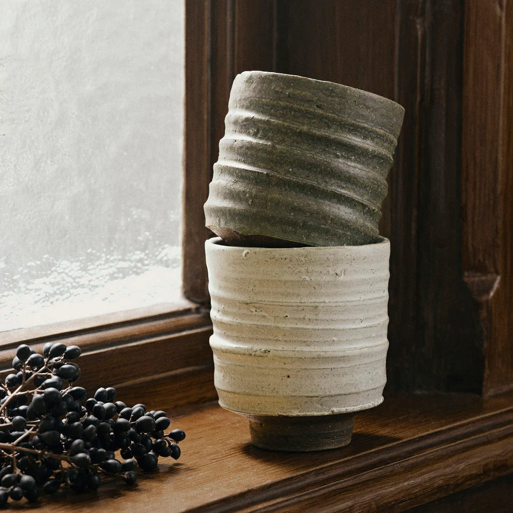 Serena Cup, Green by ferm LIVING, stacked on a windowsill
