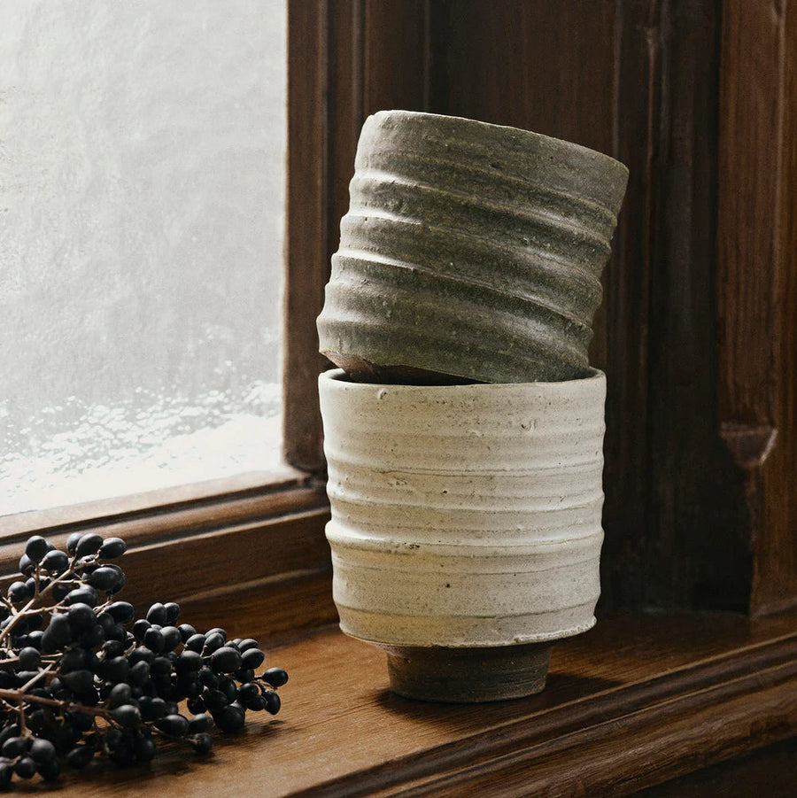 Serena Cup, Green by ferm LIVING, stacked on a windowsill