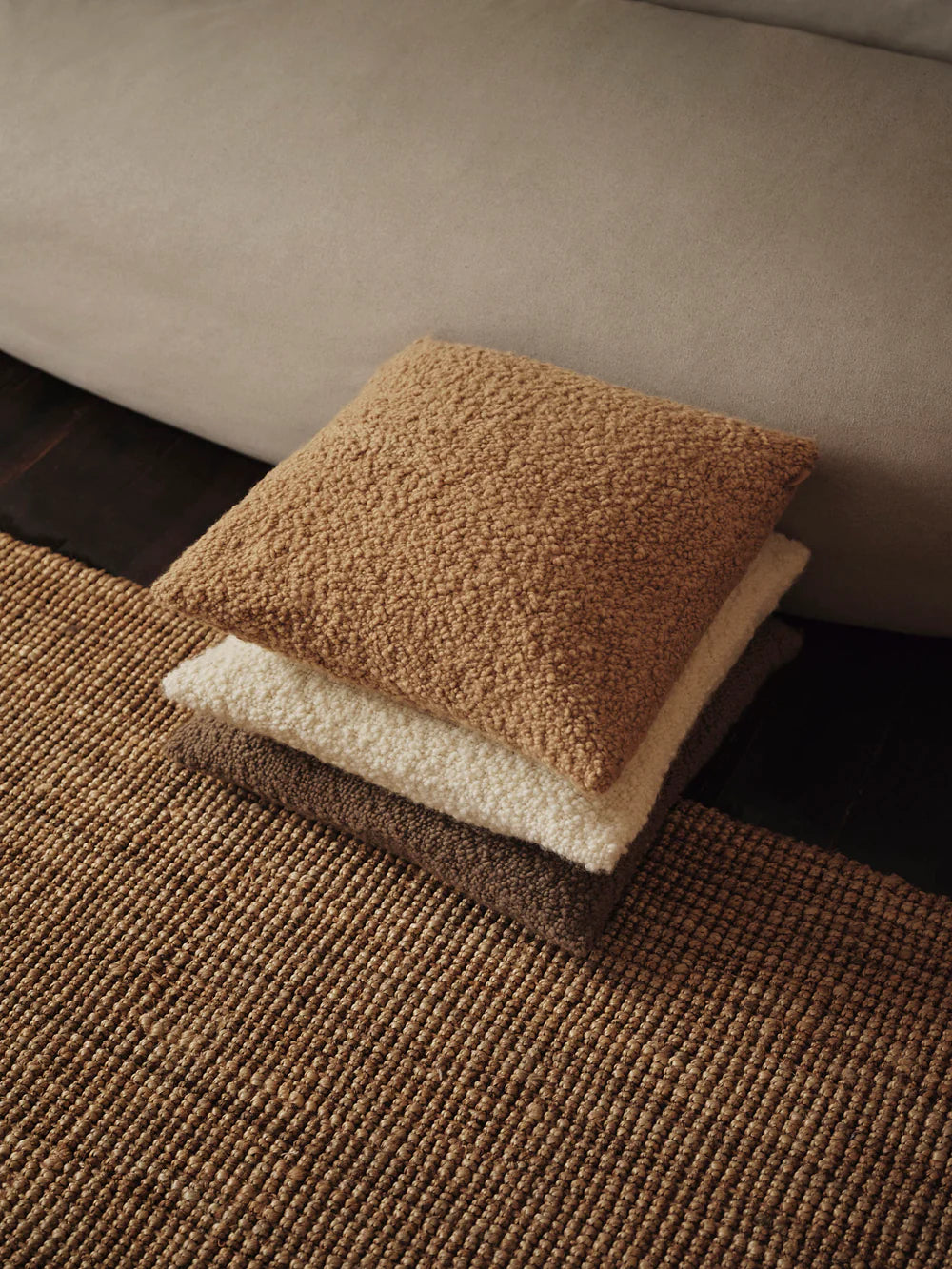 Moor Cushion, Honey by ferm LIVING, on a woven chair