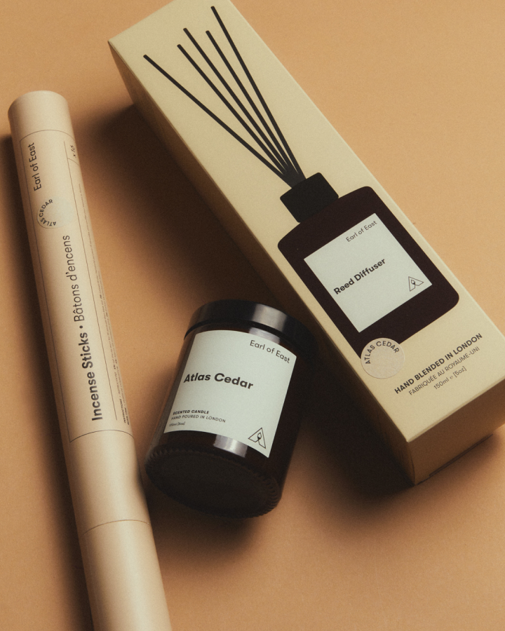 Incense sticks, diffuser bottle, and packaging on a beige background