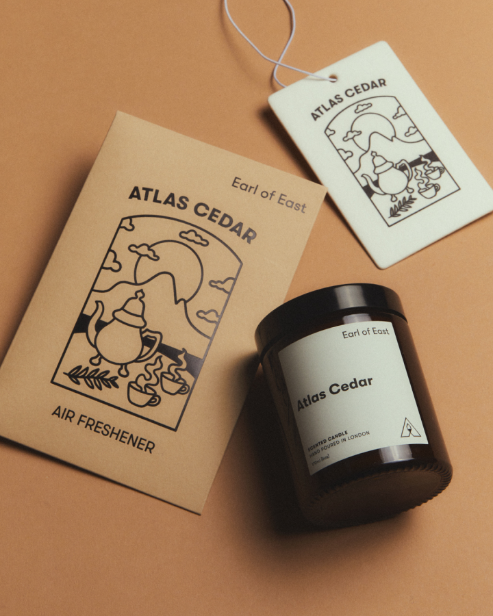 Atlas Cedar Starter Scent Set by Earl of East, with its illustrated box on tan