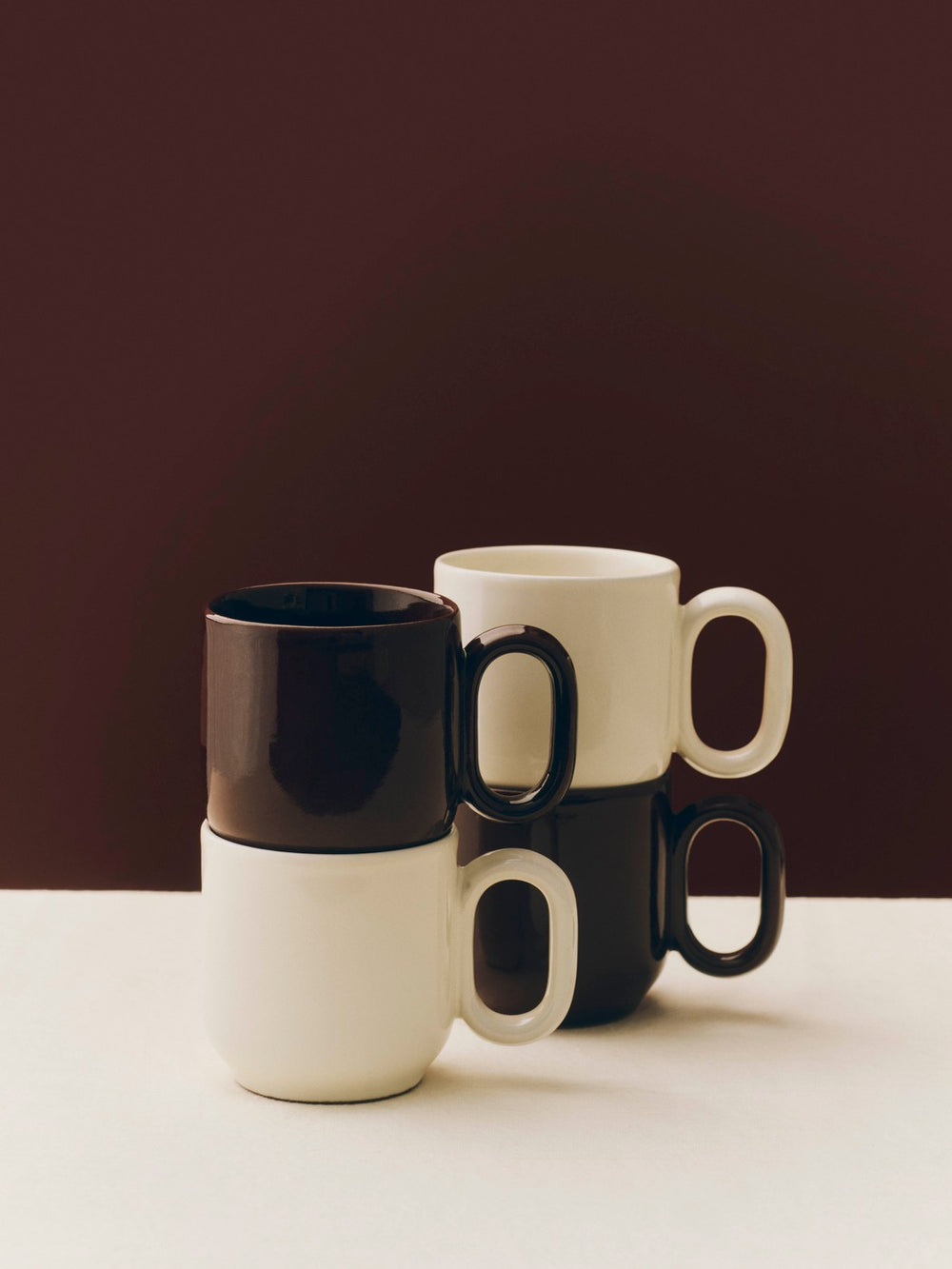 Barro Cup Set of Two, Off-White by HAY, stacked on a dark background