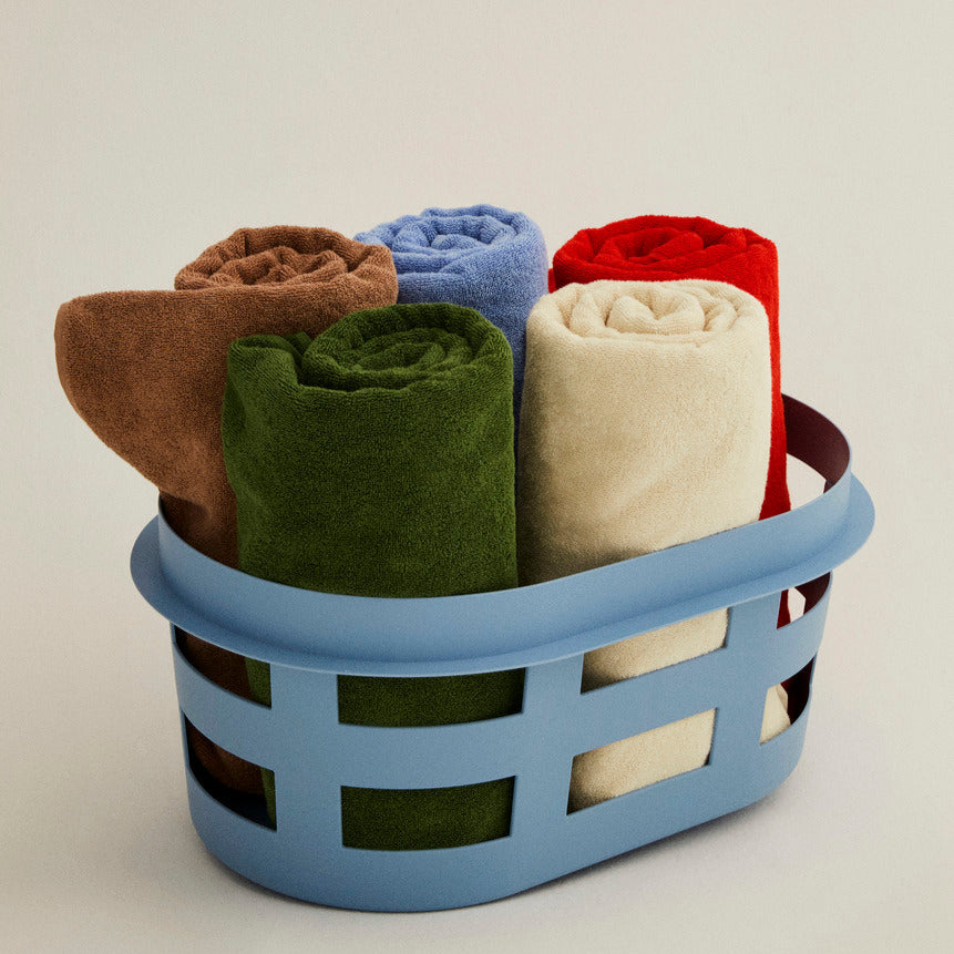Mono Wash Cloth, Cappuccino by HAY, rolled in a blue basket