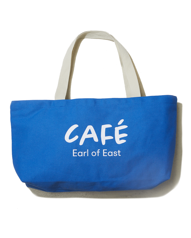  A blue cotton canvas market bag with cream handles and the text 'CAFÉ Earl of East' printed on the side. 