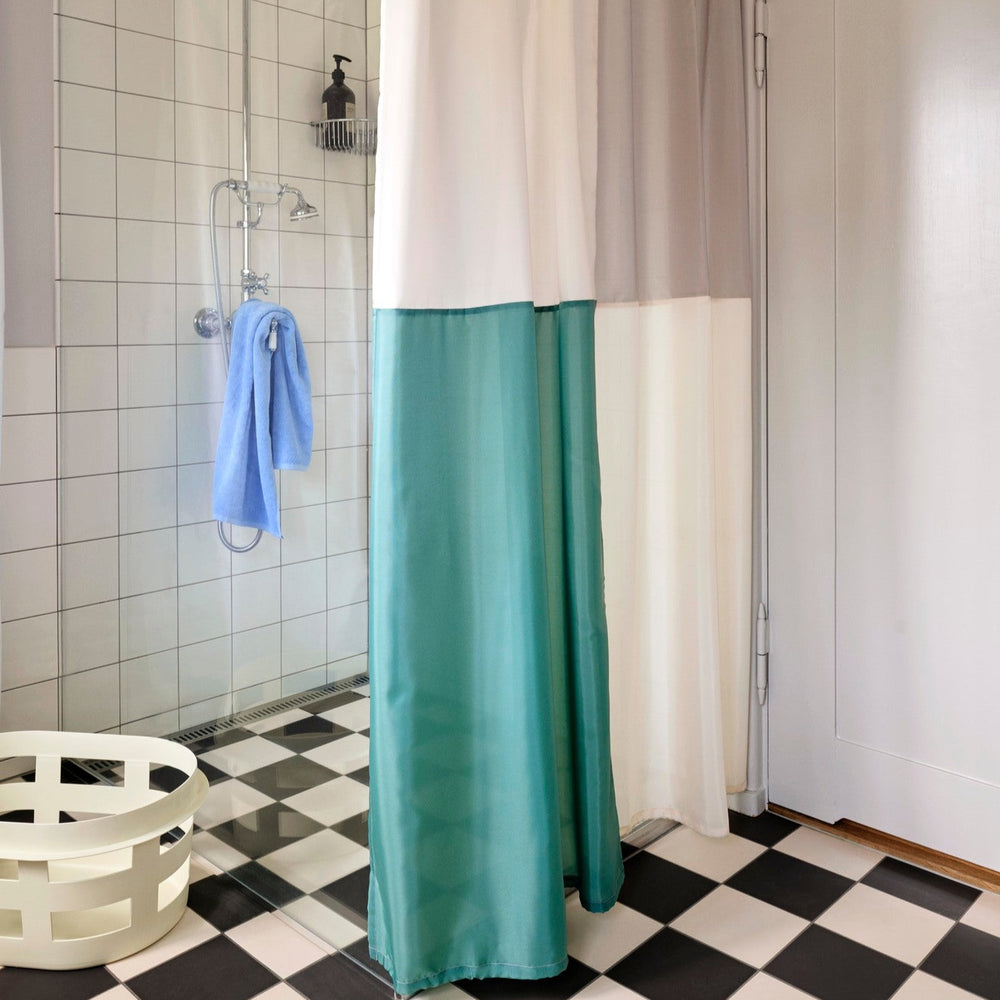 Mono Bath Towel, Sky Blue by HAY, hanging on a shower rail