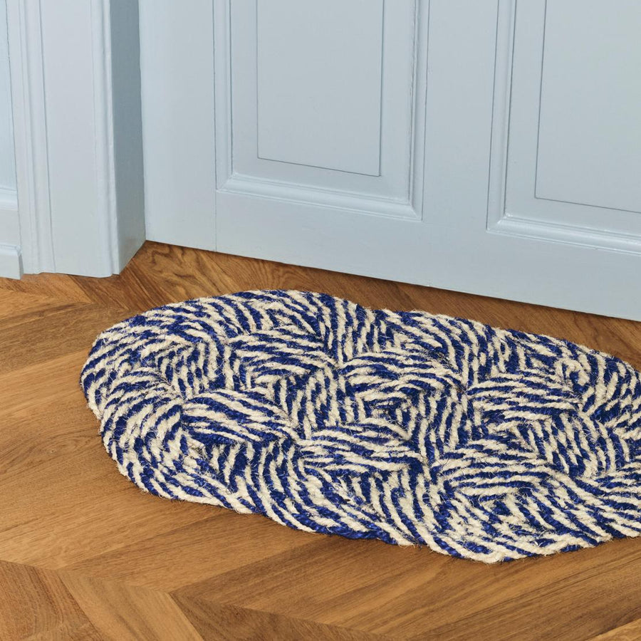 Coco Swirl Door Mat, Blue & Off-White by HAY, by a front door