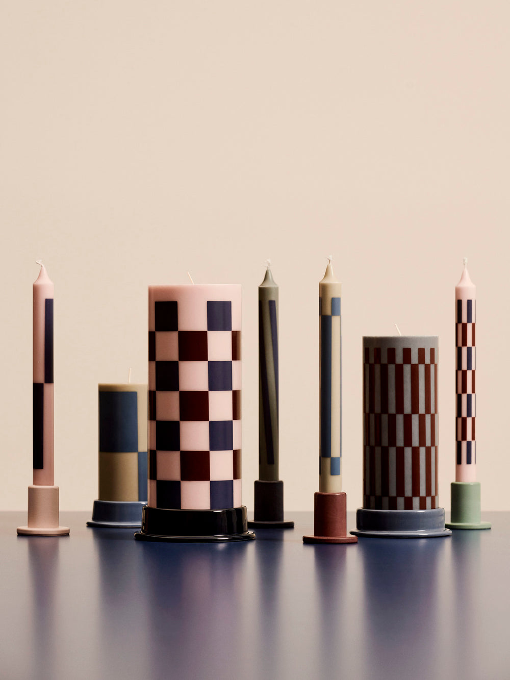 Column candles and candle holders in muted colours