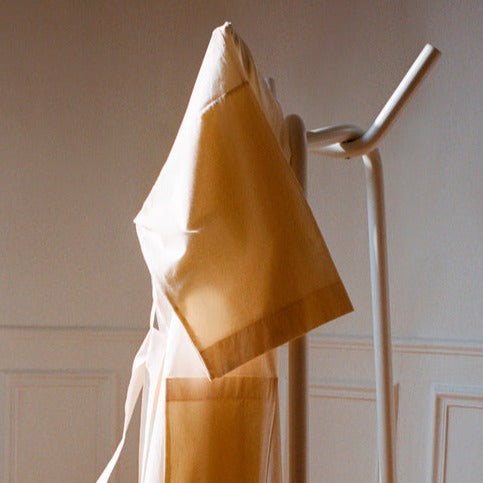 Knit Coat Rack, White by HAY, holding a yellow towel