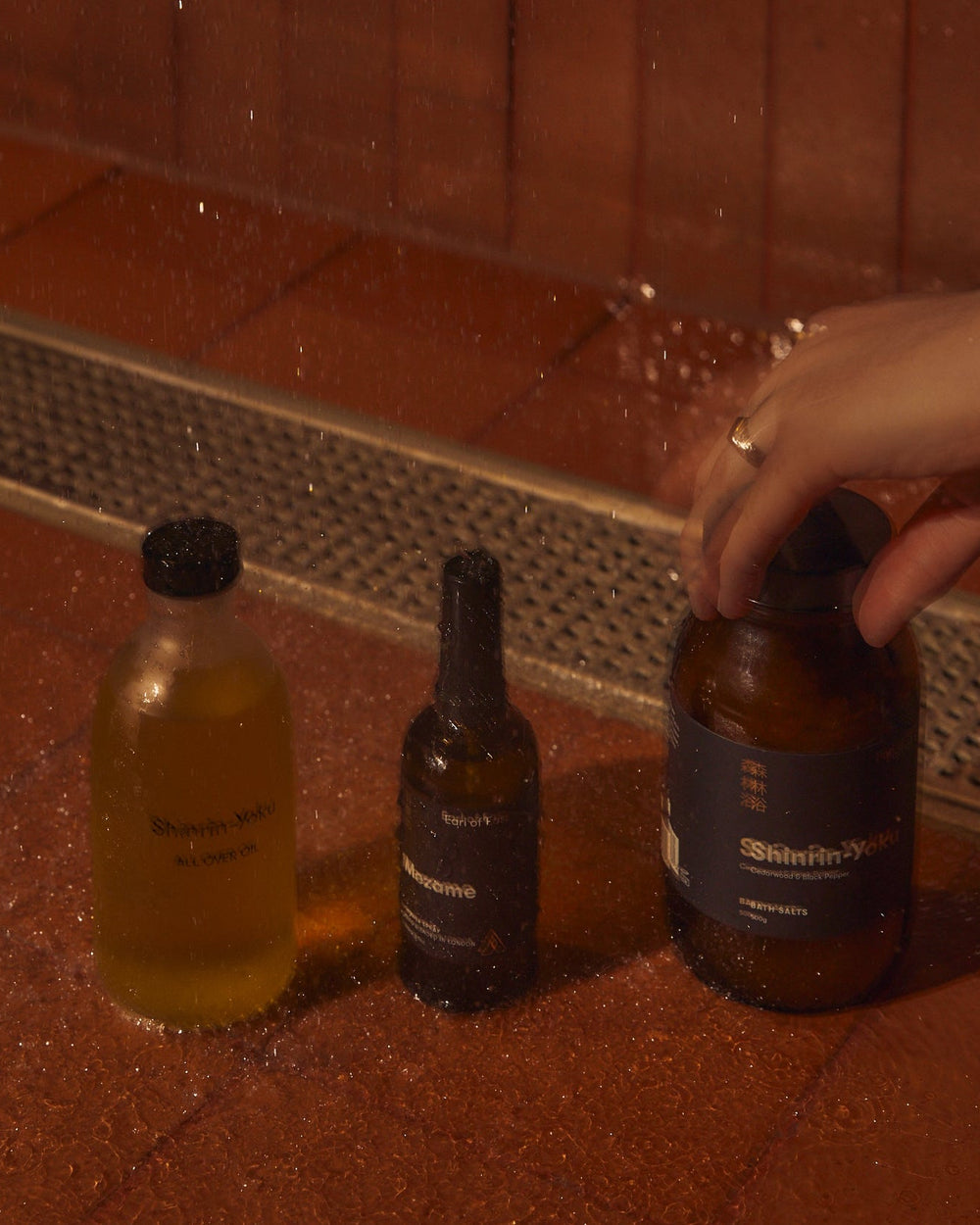 The Recovery Bundle by Earl of East, in a candlelit bathroom