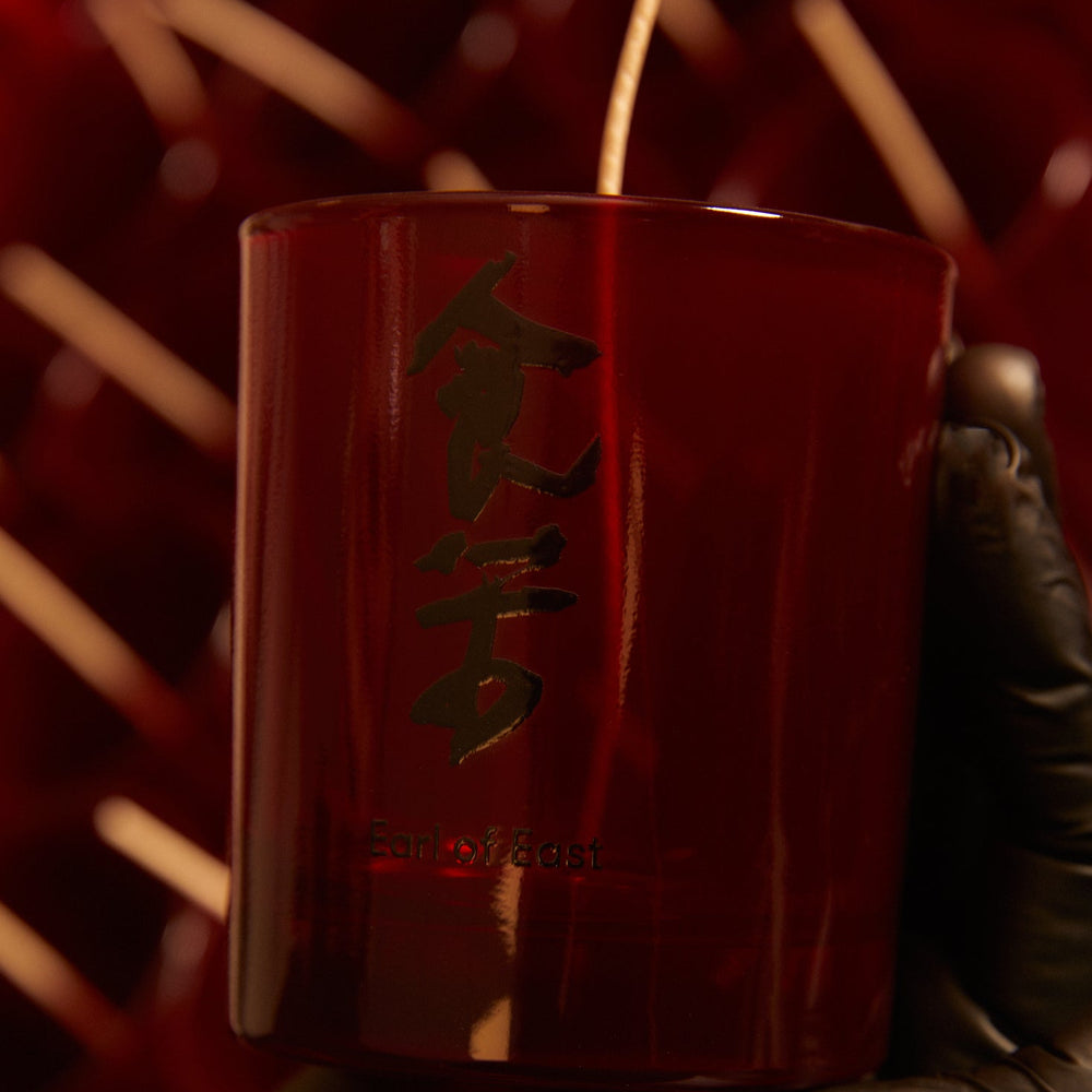 Bone Broth Scented Candle by Eat Bitter, in a red glass vessel