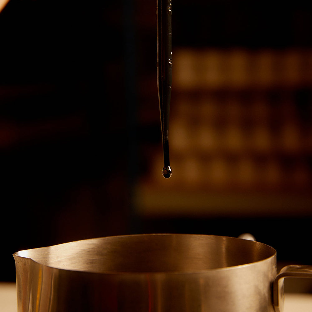 Bone Broth Scented Candle by Eat Bitter, lit, with its lid