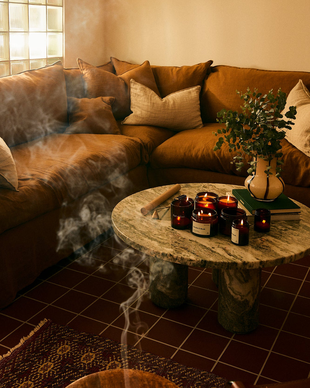 Smoke & Musk Signature Scent Bundle by Earl of East, lit in a cosy living room