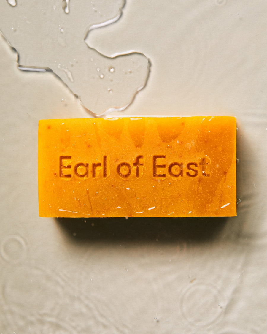 Jardin de la Lune Cleansing Bar Soap, 160g by Earl of East, hanging from a string on linen
