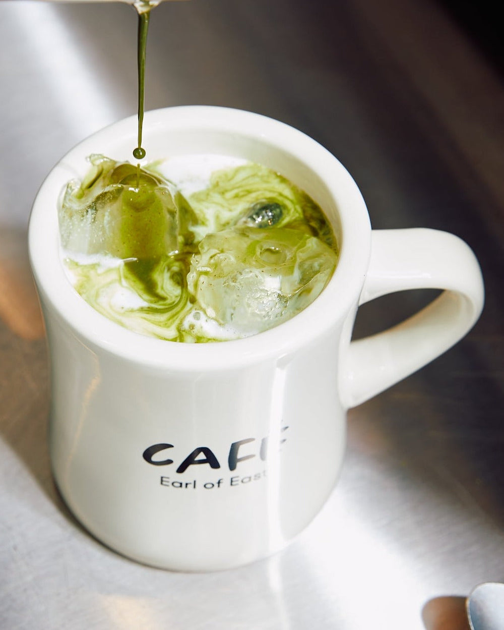 Iced Matcha Scented Candle in Mug, 300ml by Earl of East, with matcha being poured