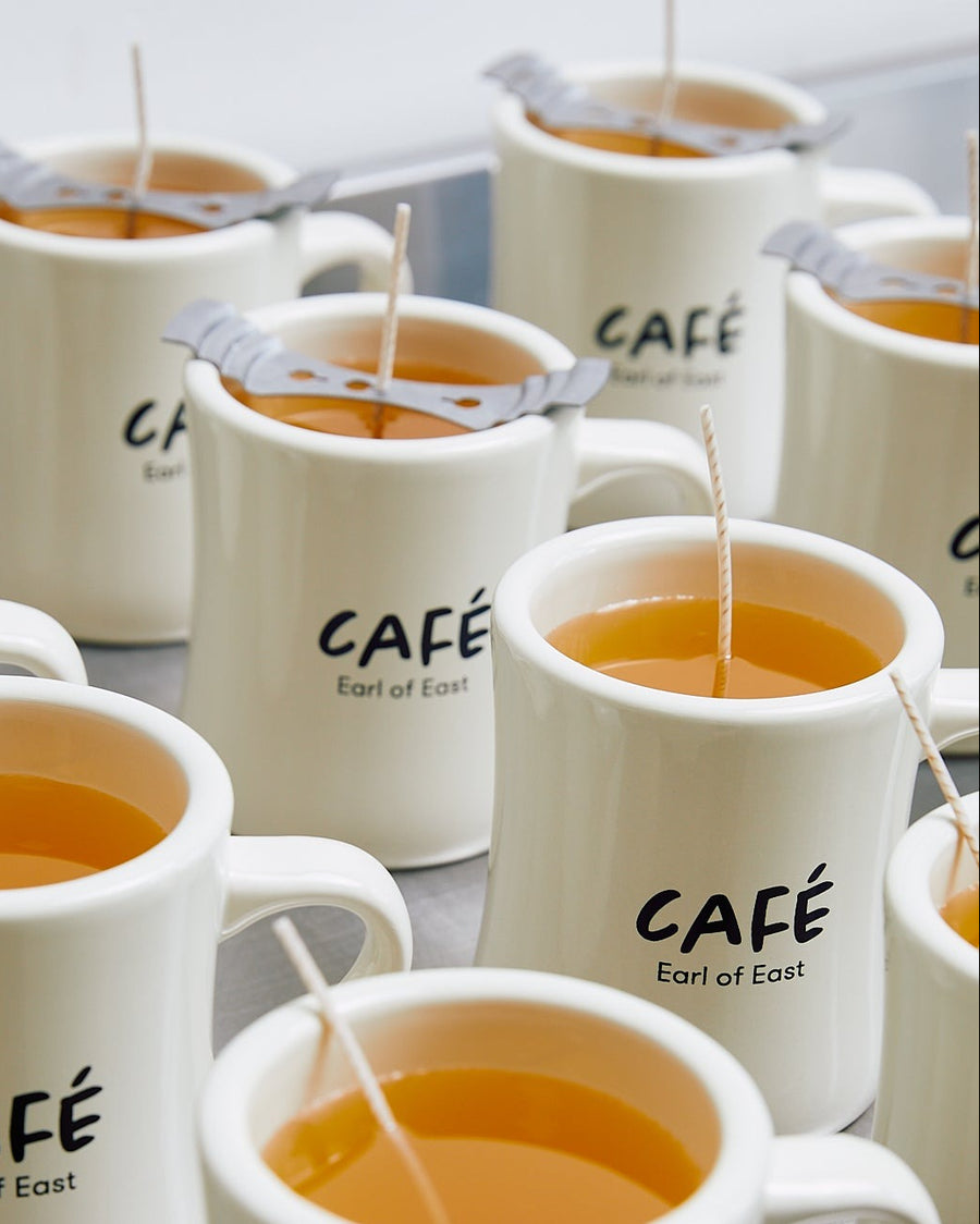 Milk Bun Scented Candle in Mug, 300ml by Earl of East, with Café mugs on a table