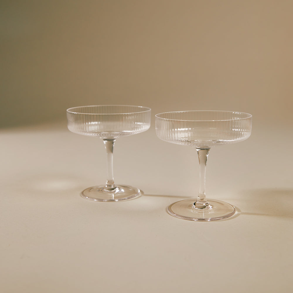 Ripple Champagne Saucer, Set of 2, Clear by ferm LIVING, on a beige background