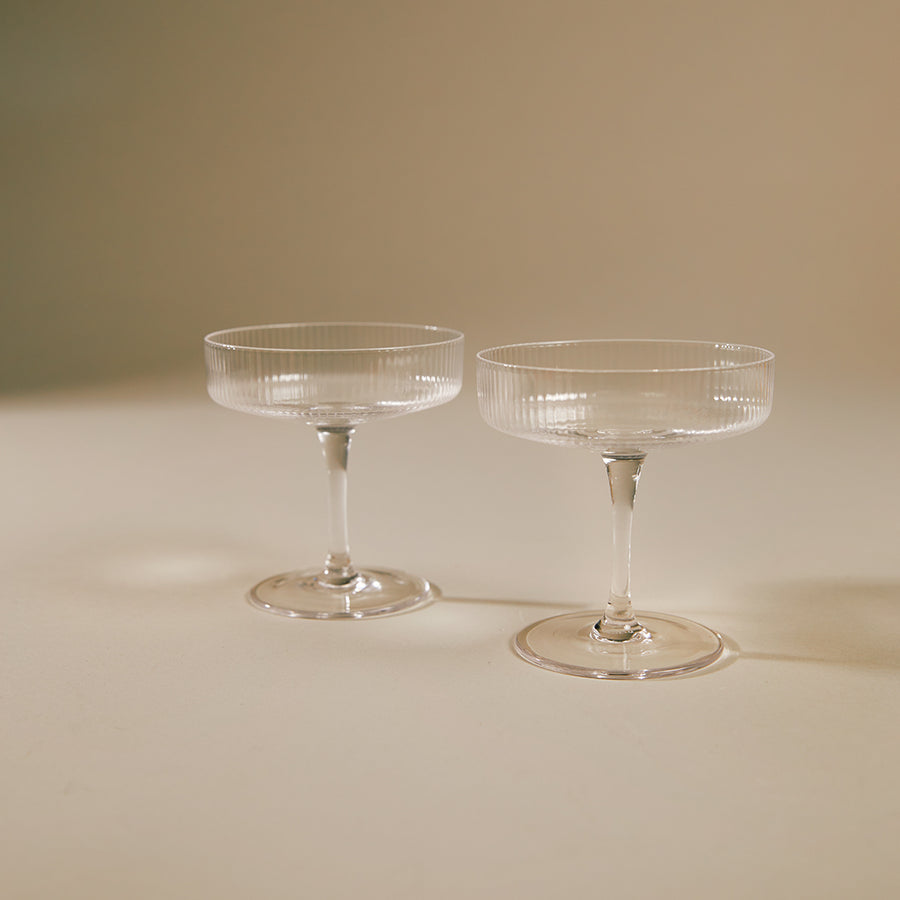 Ripple Champagne Saucer, Set of 2, Clear by ferm LIVING, on a beige background