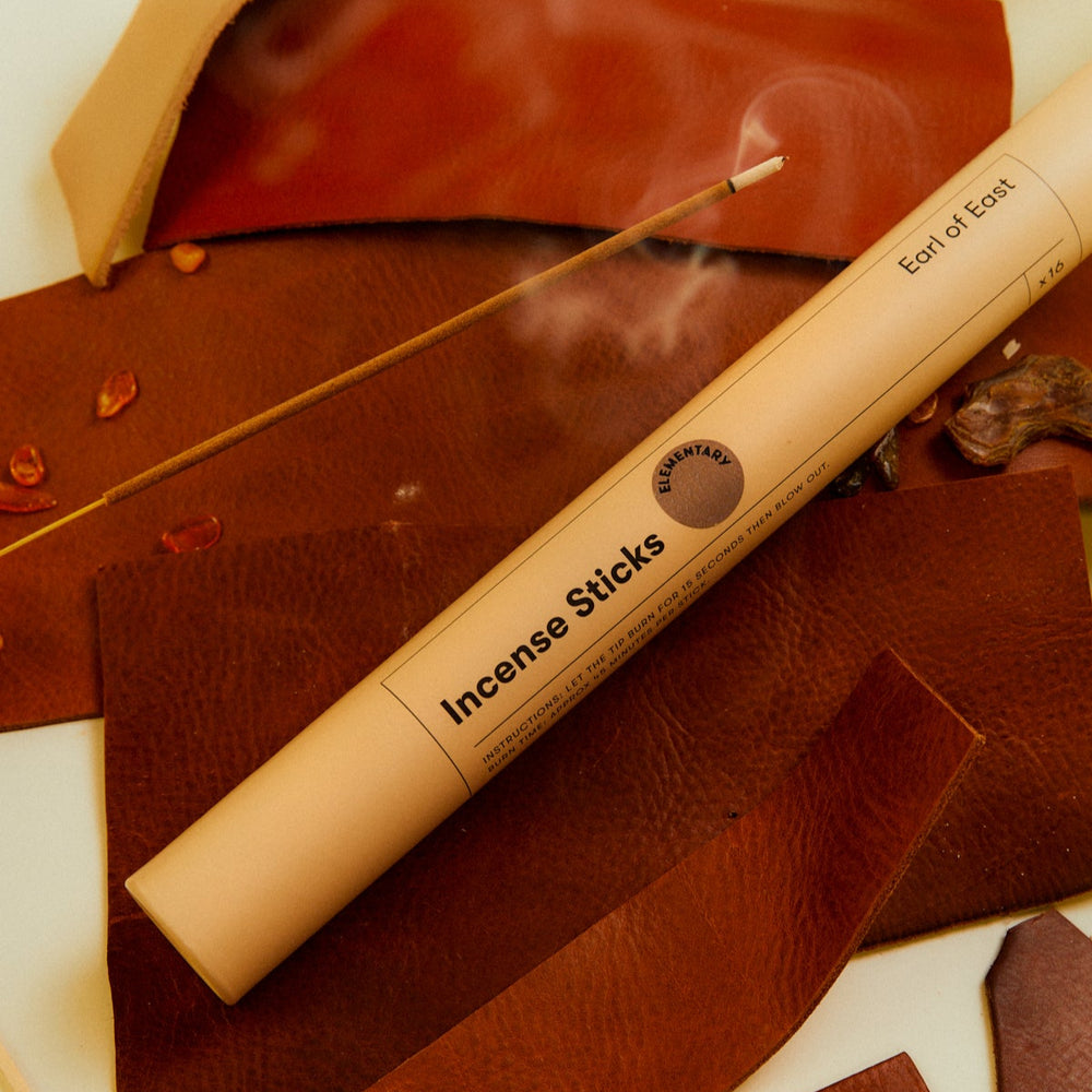 Incense Sticks, Elementary by Earl of East, tube on a brown surface