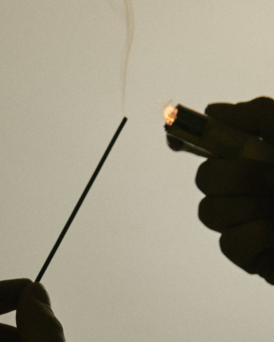 Light background with incense smoke and lighter