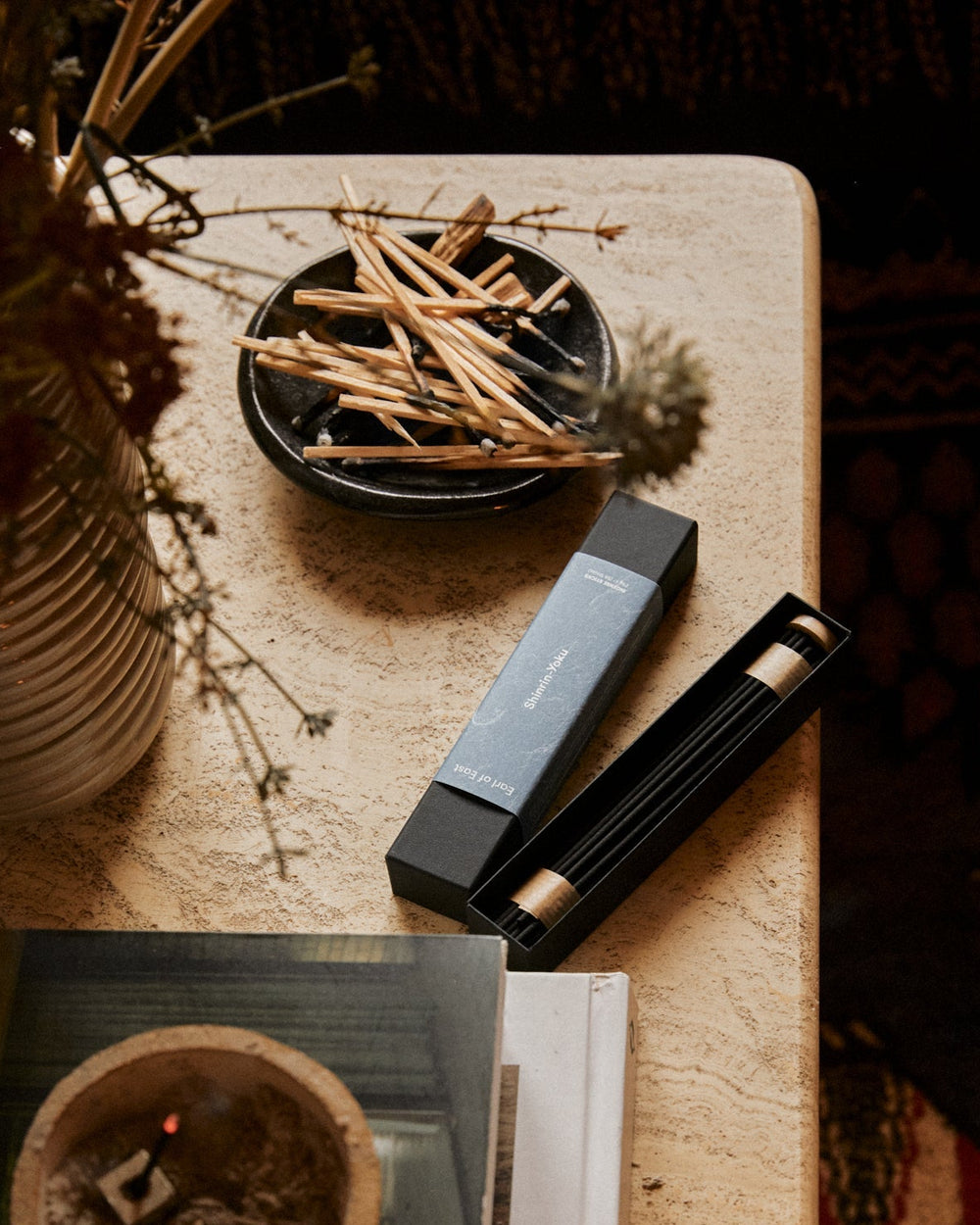 Shinrin-Yoku incense sticks burning in a modern living room setting with natural lighting