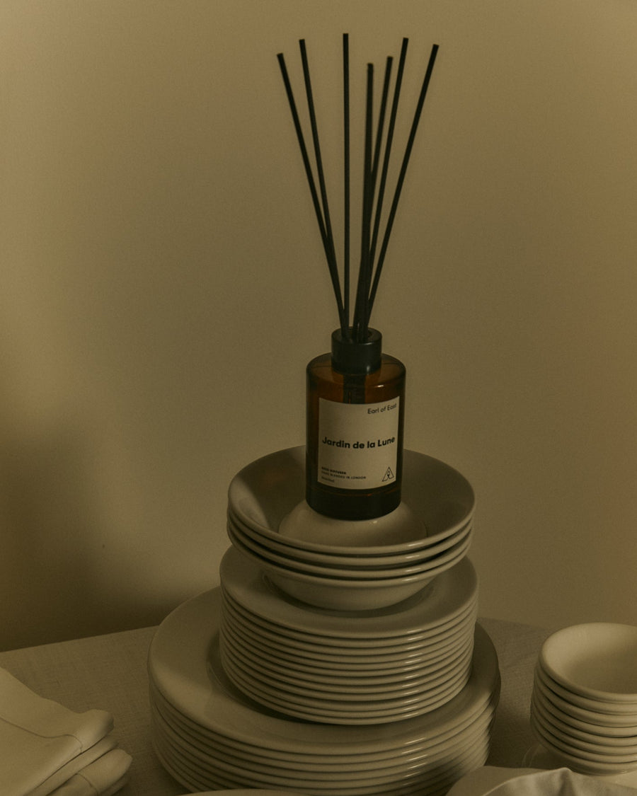 Jardin de la Lune Reed Diffuser, 150ml by Earl of East, on a stack of books