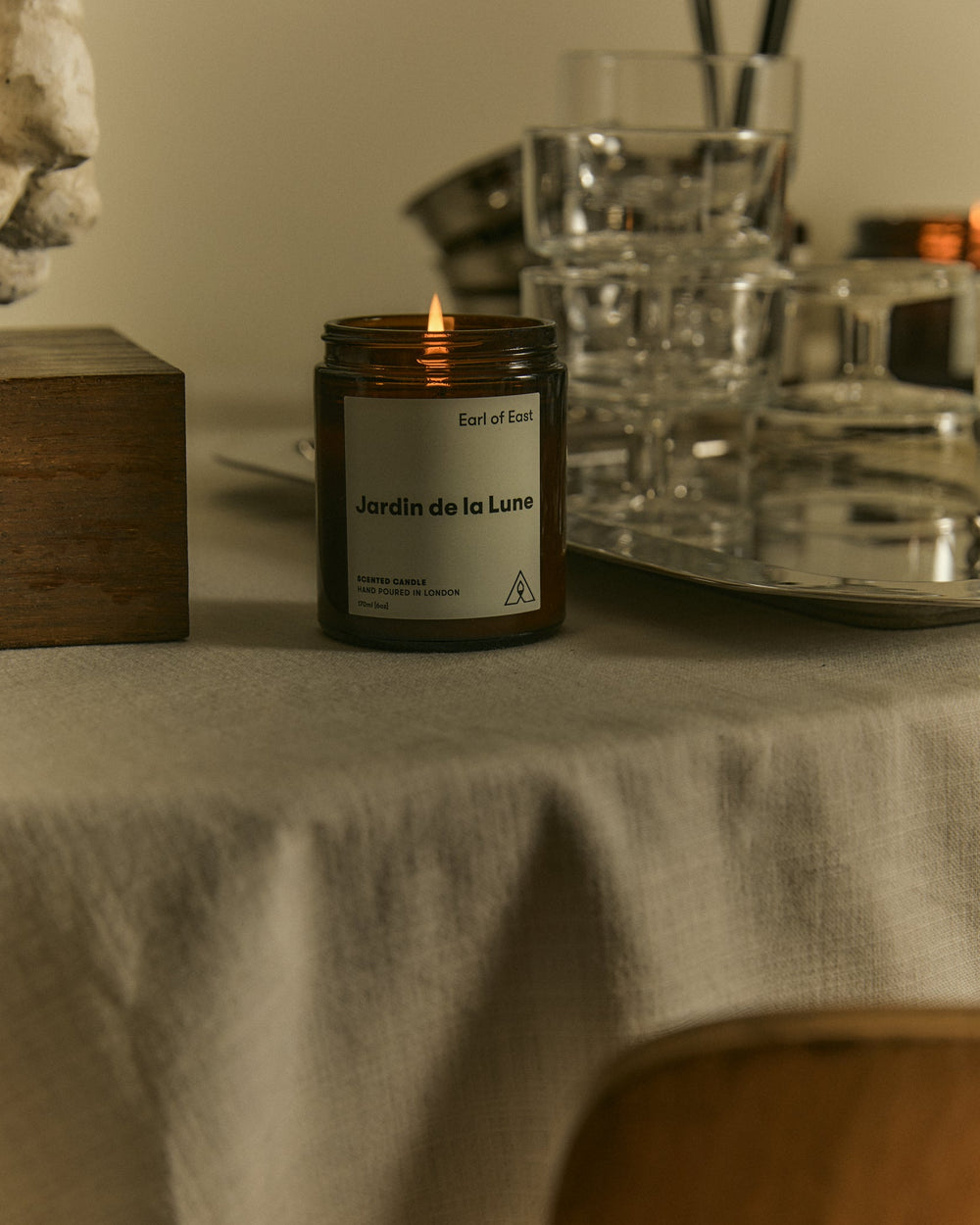 Jardin de la Lune Starter Scent Set by Earl of East, lit on a table with silverware