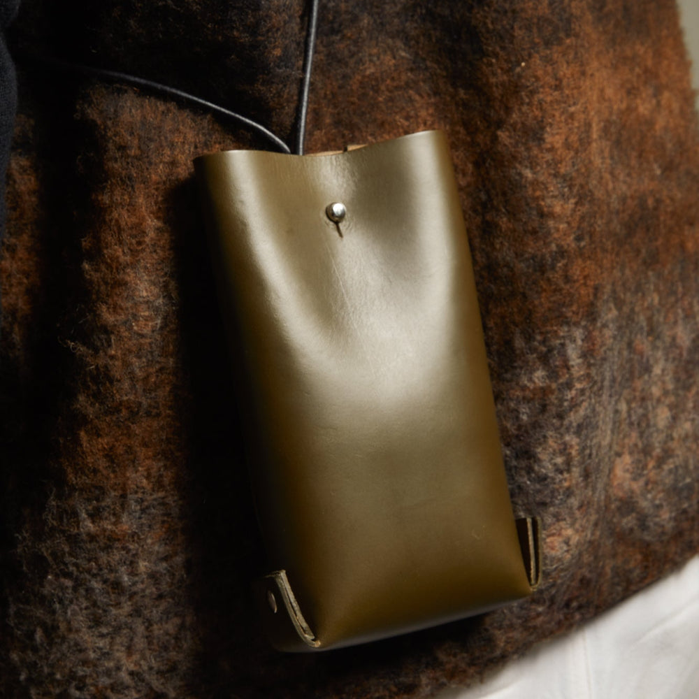 Leather Jigsaw Pouch, Olive by Earl of East x Kate Sheridan, held in hand