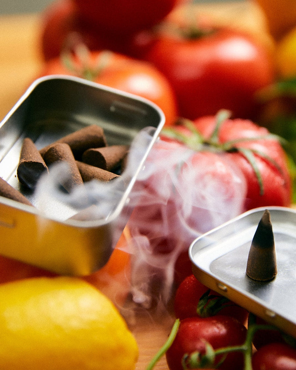 Greenhouse Incense Cones by Earl of East, tin open among tomatoes and peppers