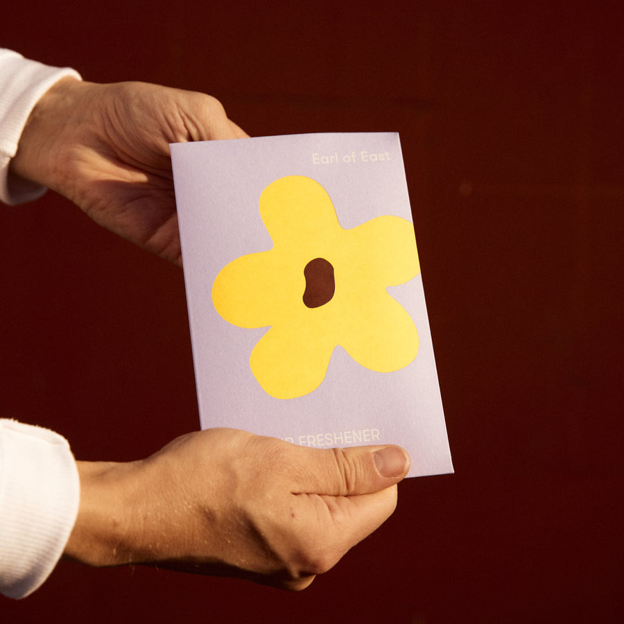 Flower Power, Air Freshener by Earl of East, held in hand with its card