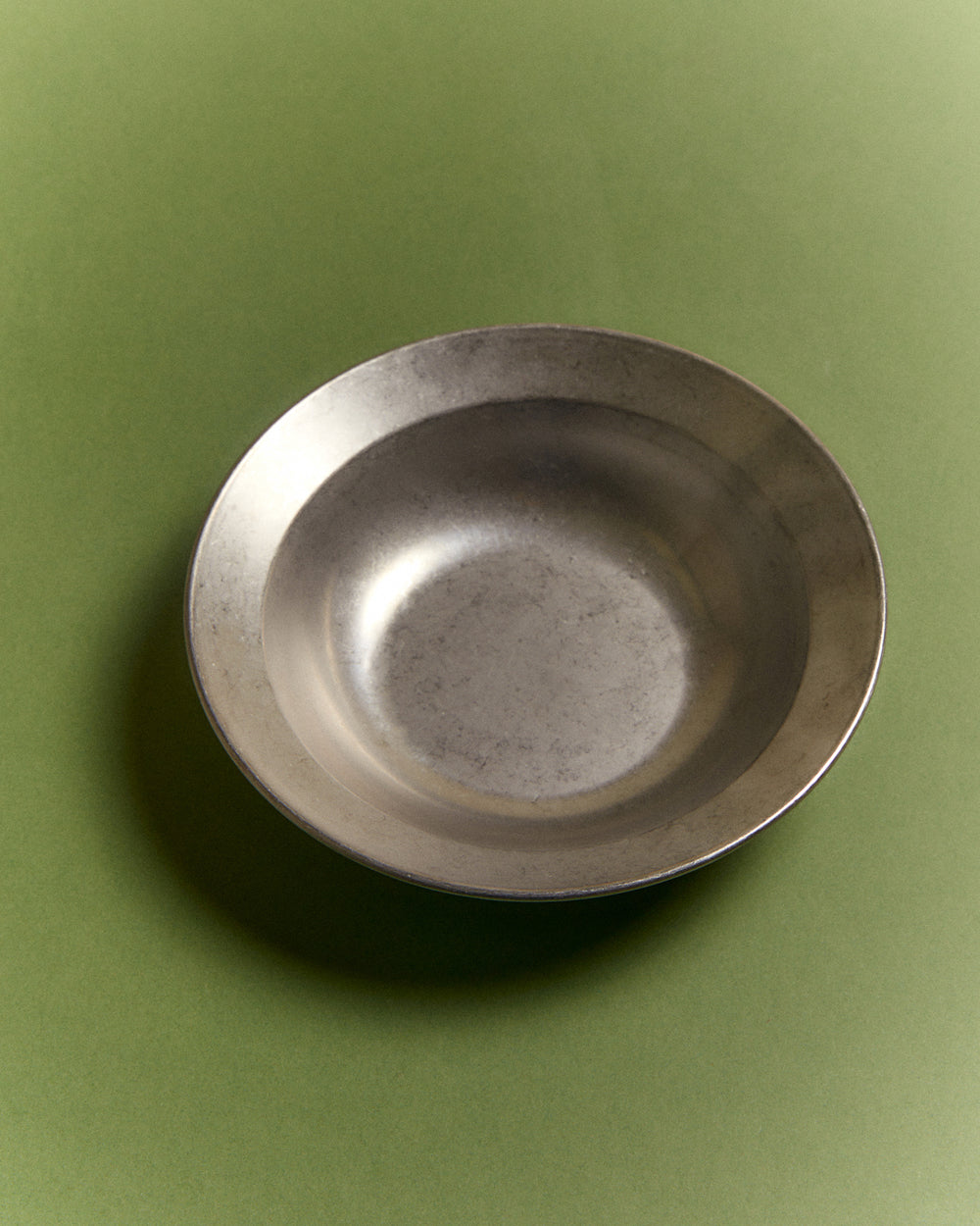 Small Serving Bowl, Vintage Stainless Steel by Earl of East, on a green background