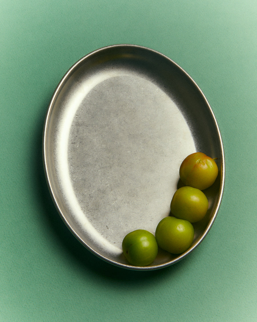Small Oval Serving Dish, Vintage Stainless Steel by Earl of East, holding limes on green