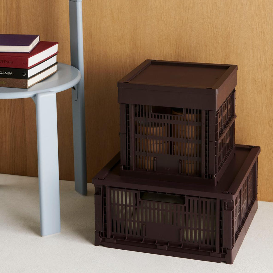Colour Crate, Medium, Bordeaux by HAY, stacked holding books on a shelf