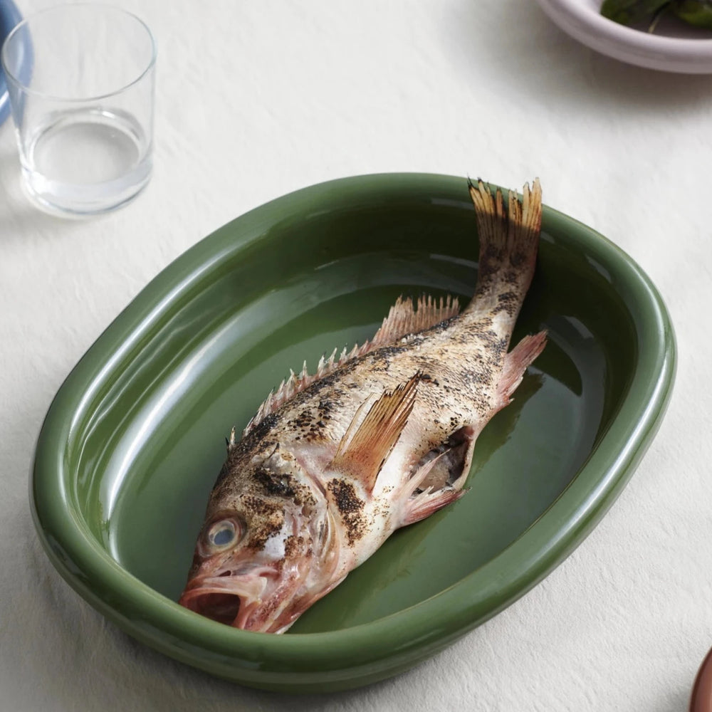 Barro Oval Dish, Large, Green by HAY, holding a whole fish