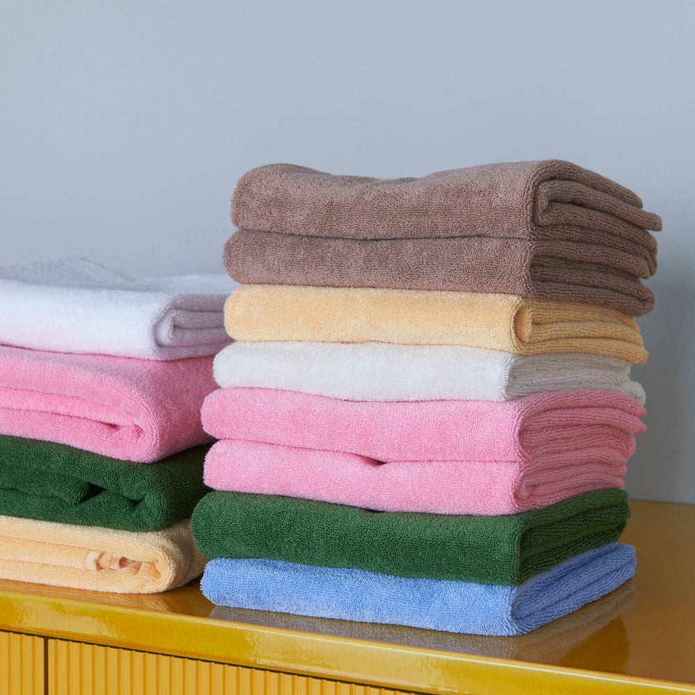 Mono Hand Towel, Cappuccino by HAY, stacked in a range of colours